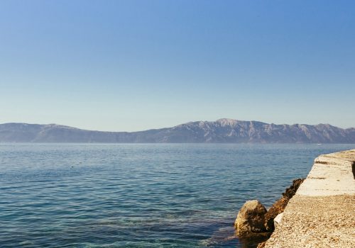 calm-idyllic-sea-with-mountain-clear-blue-sky